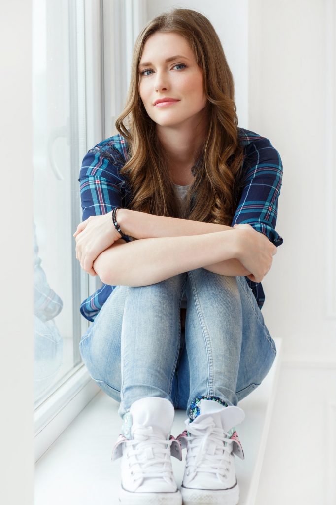 Attractive girl by the window